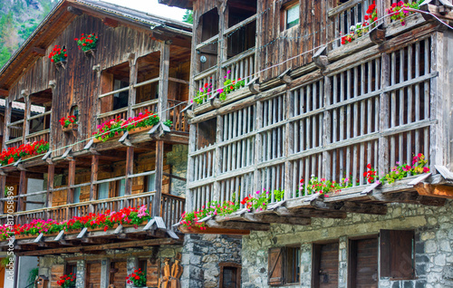 flowered balconies in the traditional ancient wooden houses of Sappada