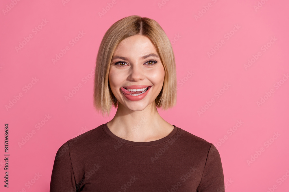 Fototapeta premium Photo of adorable charming girl wear stylish brown clothes lick teeth isolated on pink color background
