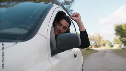 Boy In White Car Looks Out Of Window And Exults Smiling photo