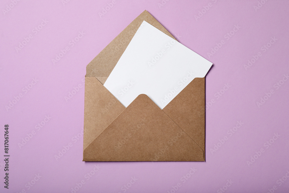 Letter envelope with card on violet background, top view Letter envelope with card on violet background, top view