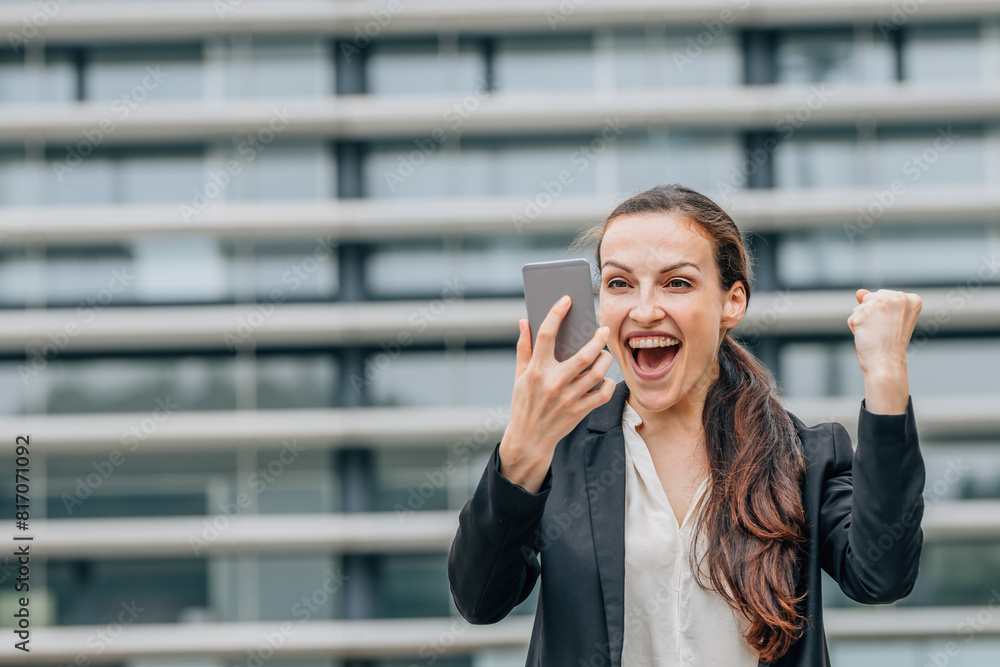 business woman looking at mobile phone with successful expression business woman looking at mobile phone with successful expression