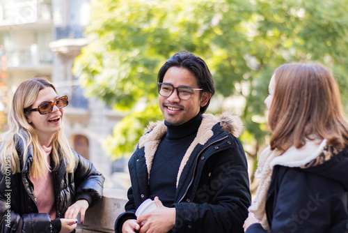 Multi-ethnic friends walking in the street, talking and laughing