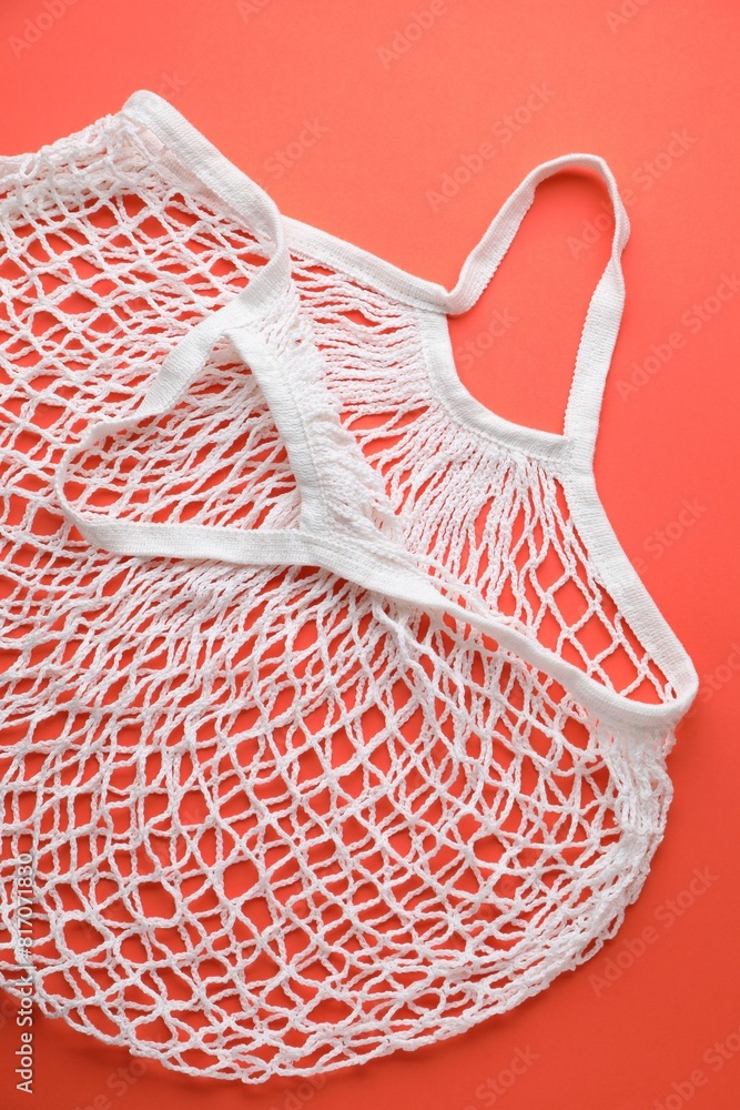 Obraz premium White string bag on red background, top view