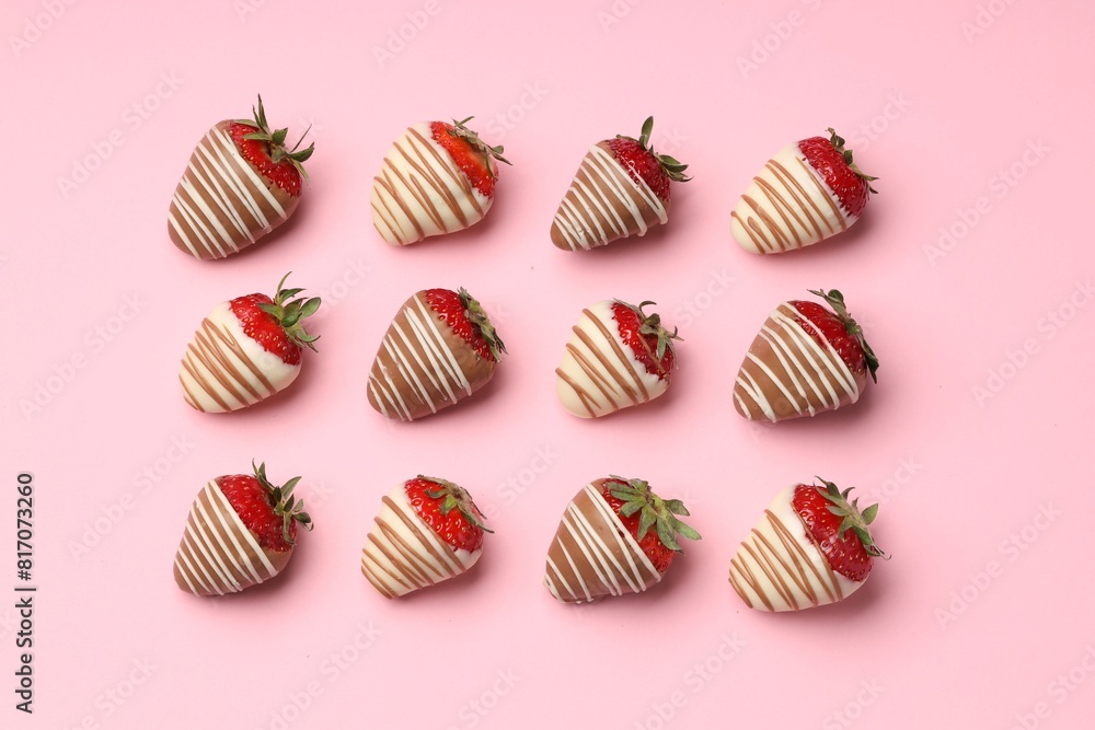 Delicious chocolate covered strawberries on pink background, flat lay Delicious chocolate covered strawberries on pink background, flat lay