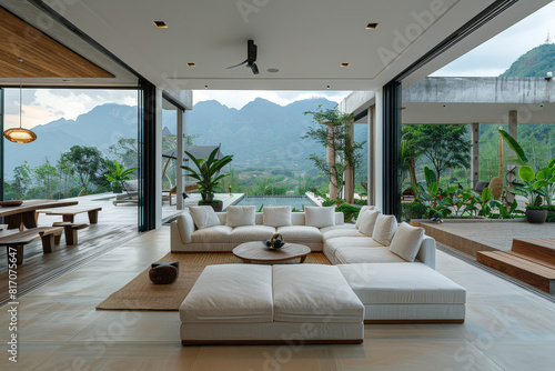 A spacious living room with floor-to-ceiling windows showcasing a breathtaking view of the mountains in the distance © AI Exclusive 