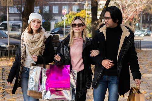 Multi-ethnic friends walking in the street, talking and laughing