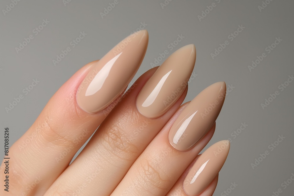Close-up photo showcasing a beautiful hand with elegant nude stiletto manicure, perfect for fashion and beauty concepts with a backdrop ideal for cosmetic advertising Close-up photo showcasing a beautiful hand with elegant nude stiletto manicure, perfect for fashion and beauty concepts with a backdrop ideal for cosmetic advertising