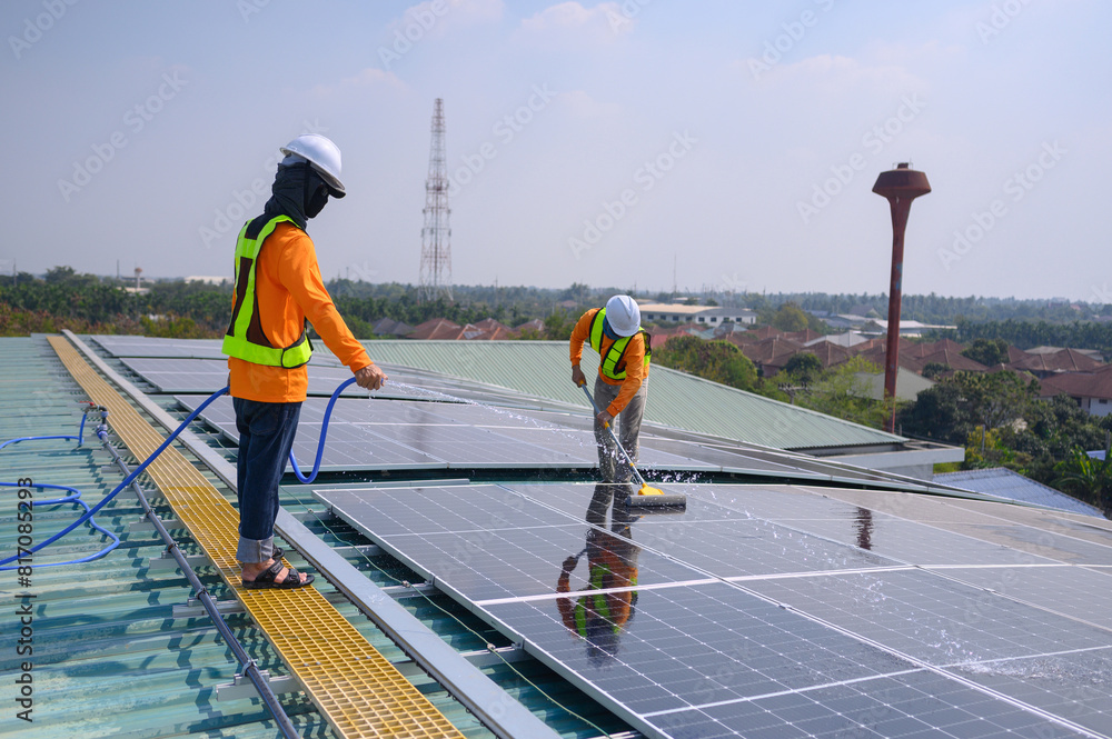 A team of engineers takes care of cleaning the solar panels outside the building. Installing solar cells on the roof Solar panels on the roof A team of engineers takes care of cleaning the solar panels outside the building. Installing solar cells on the roof Solar panels on the roof