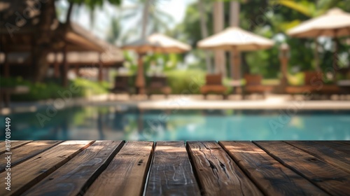 Image of wood table in front of swimming pool blur background. Brown wooden desk empty counter front view of the poolside on beautiful beach resort and outdoor spa. © May