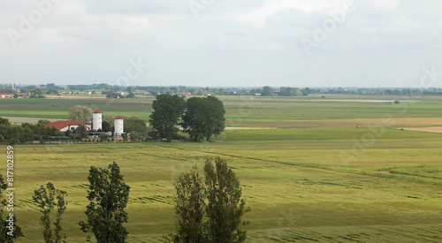 view of the plain with vast cultivated fields and no hills on the horizon and a farm photo