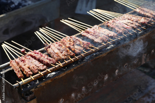 Arrosticini are a class of traditional dishes of skewered grilled meat typical of Abbruzzo and Molise regions in Italy photo