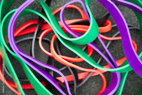 Sports equipment for pumping muscles . Background of colorful rubber elastic bands