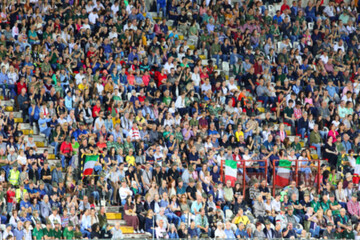 Intentionally blurred background of many people in the packed stands of the stadium during the event and the faces are not recognizable
