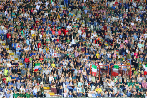 Intentionally blurred background of many people in the packed stands of the stadium during the event and the faces are not recognizable