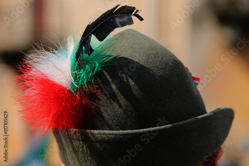 hat with the black feather typical of the uniform of the Alpini mountain troops of the Italian Army and with a tricolor decoration with the colors photo