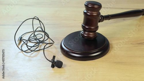 Judge gavel for adjudication and Lavalier microphone. Law and justice to privacy information and audio recording. Court of law to journalism and bloggers. Pronouncing sentence, striking Gavel.