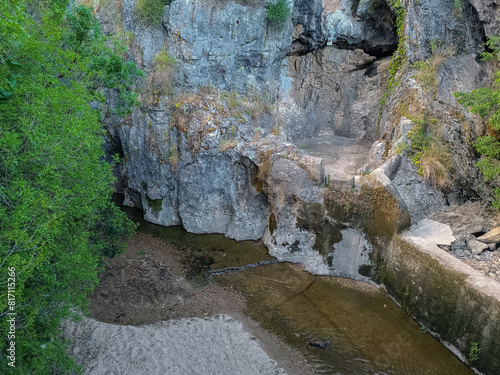 Cliff with cove in the source of the Alviela river on Olhos d'Água beach at evening, Louriceira - Alcanena PORTUGAL photo