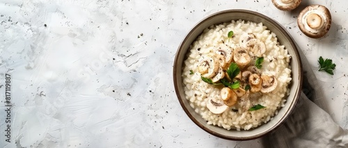 Top view of a creamy Italian risotto with mushrooms, using the rule of thirds, with ample copy space