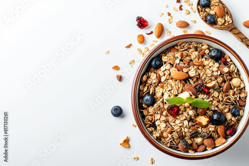 Appetizing muesli in a plate on the table. View from above. White background, white table. Layout design. Copy space, free space for your text.