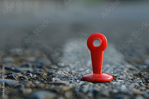 A red pin in the middle of a road photo