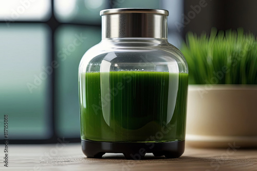 Concentrated wheatgrass shot in a transparent glass with lush green blades and juicer.  