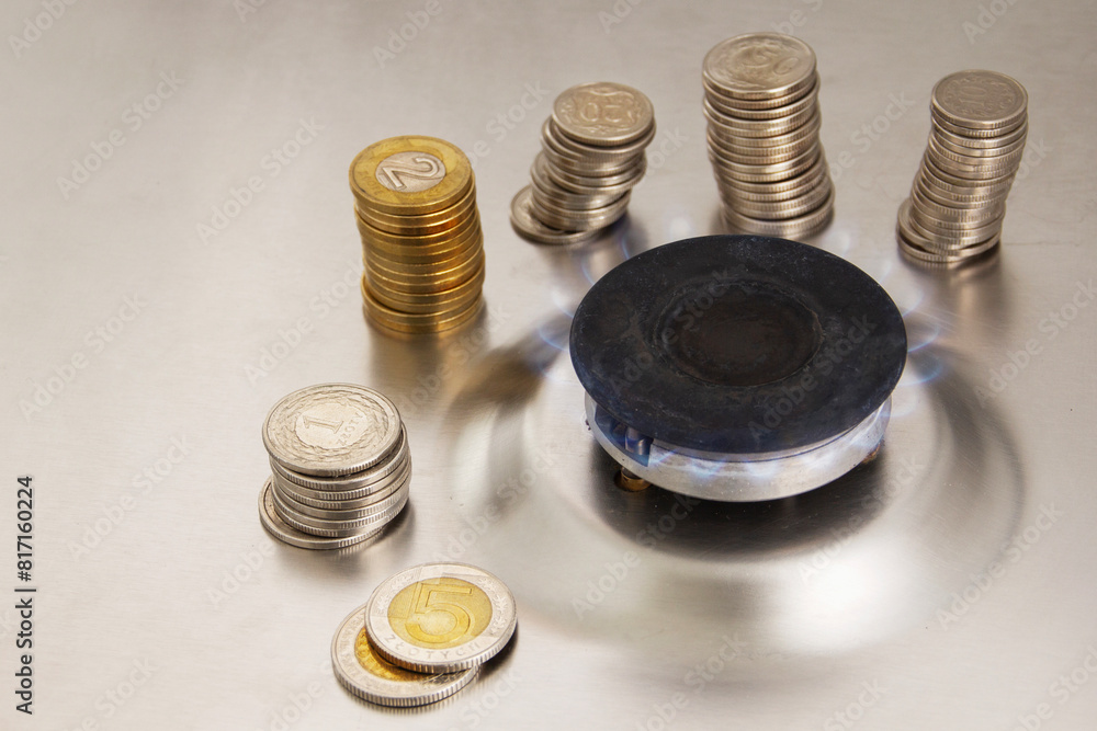gas stove and coins on a gray background gas stove and coins on a gray background