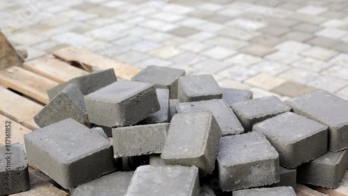Close-up of Concrete Pavers, Close-up view of gray concrete pavers stacked on a wooden pallet, highlighting the texture and solid construction material.
