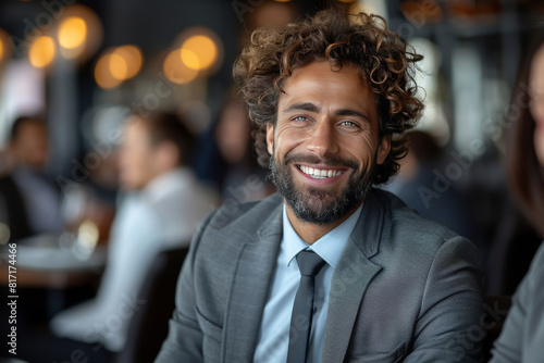 Portrait of smiling businessman at business meeting in restaurant with partners.