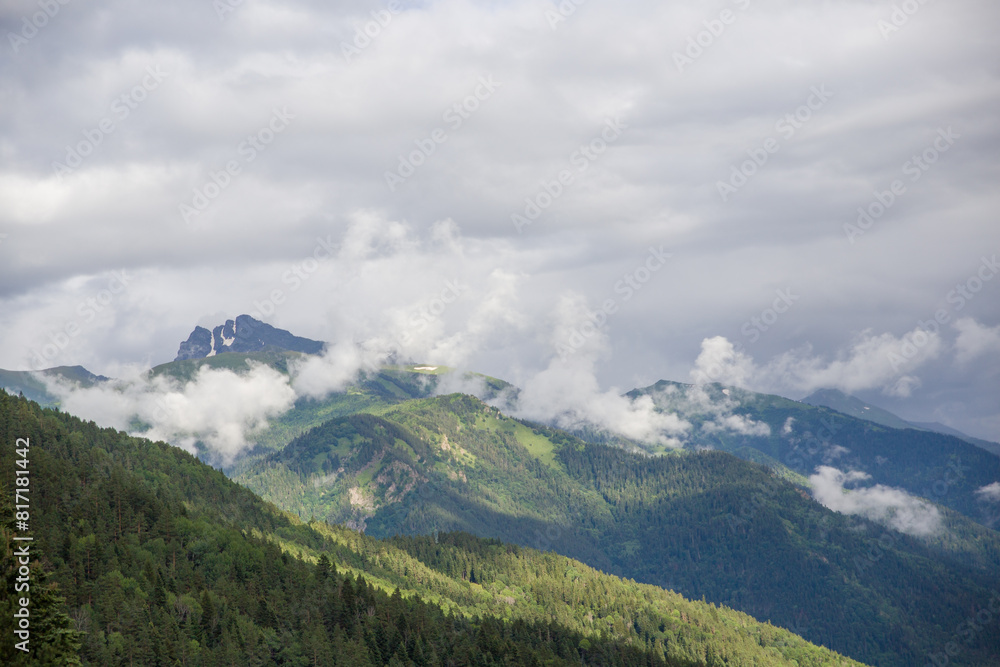 Clouds float over the mountains. overgrown with forest. Clouds float over the mountains. overgrown with forest.