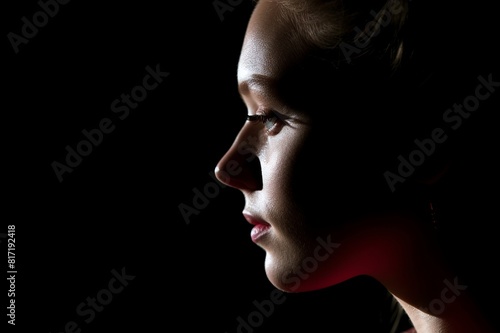 profile portrait of young woman in shadow