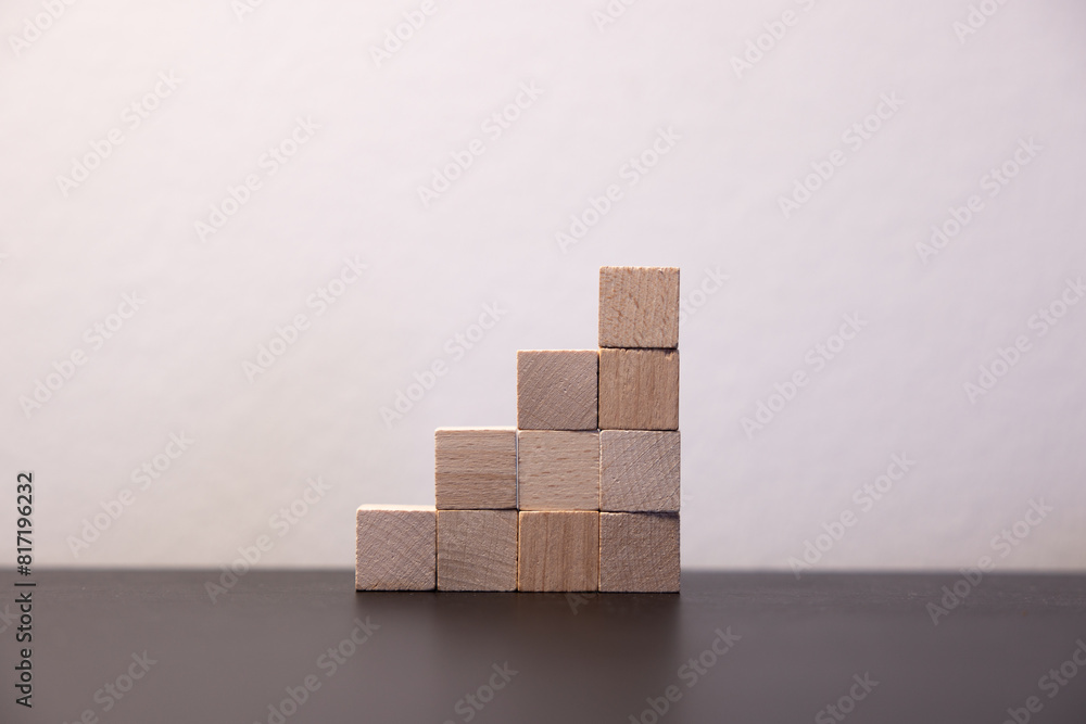 Hand putting and stacking blank wooden cubes on table with copy space for input wording and infographic icon. Hand putting and stacking blank wooden cubes on table with copy space for input wording and infographic icon.