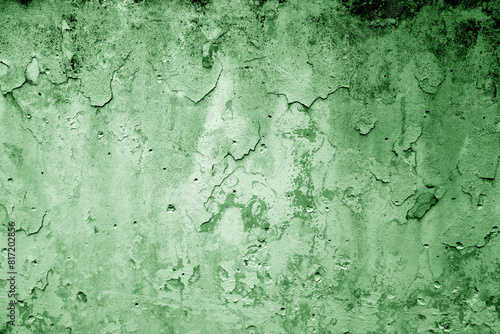 Peeling paint on grungy plaster wall. Green color.