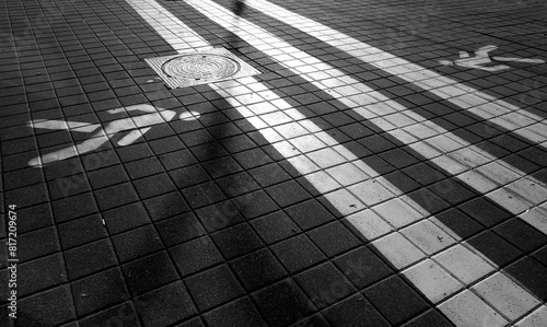 Pedestrian crosswalk sign painted on the road surface. Black and white