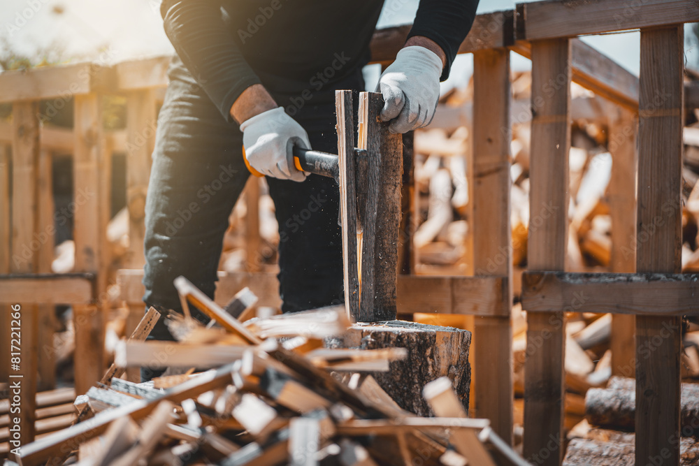 Axe cutting wood block. Concept of preparation firewood for kindling and heating the house. Man holding light axe during kindling preparation. Axe cutting wood block. Concept of preparation firewood for kindling and heating the house. Man holding light axe during kindling preparation.