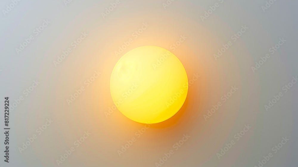 Yellow sphere light fixture against a gray background. Minimalistic design for interior decor and lighting concept. Yellow light effect ball planted on light background, top view. Yellow sphere light fixture against a gray background. Minimalistic design for interior decor and lighting concept. Yellow light effect ball planted on light background, top view.