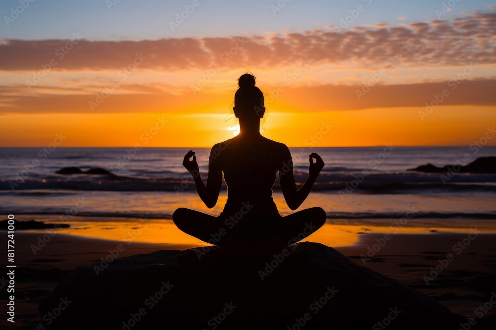 Sunset, beach and silhouette of a woman in a lotus pose while doing a yoga exercise by the sea. Peace, zen and shadow of a calm female doing meditation or pilates workout outdoor at dusk by the ocean Sunset, beach and silhouette of a woman in a lotus pose while doing a yoga exercise by the sea. Peace, zen and shadow of a calm female doing meditation or pilates workout outdoor at dusk by the ocean