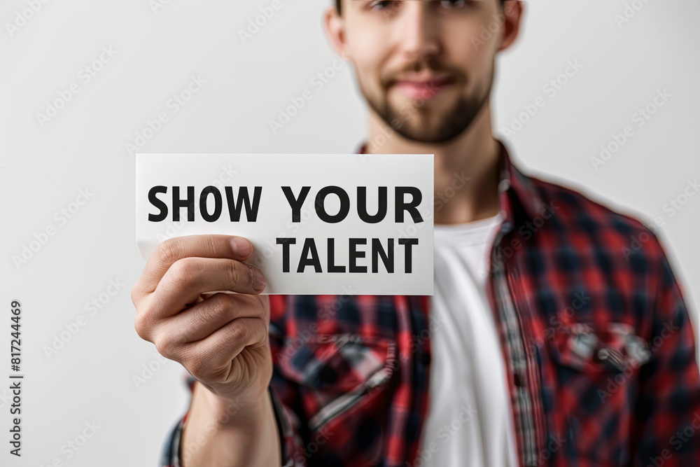 Man holding a card with the text Show your talent on white background, with writing “ SHOW YOUR TALENT “
Man holding a card with the text Show your talent on white background, with writing “ SHOW YOUR TALENT “