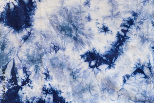 Close-up batik shirt with indigo blue dye on white fabric cotton background on top-view