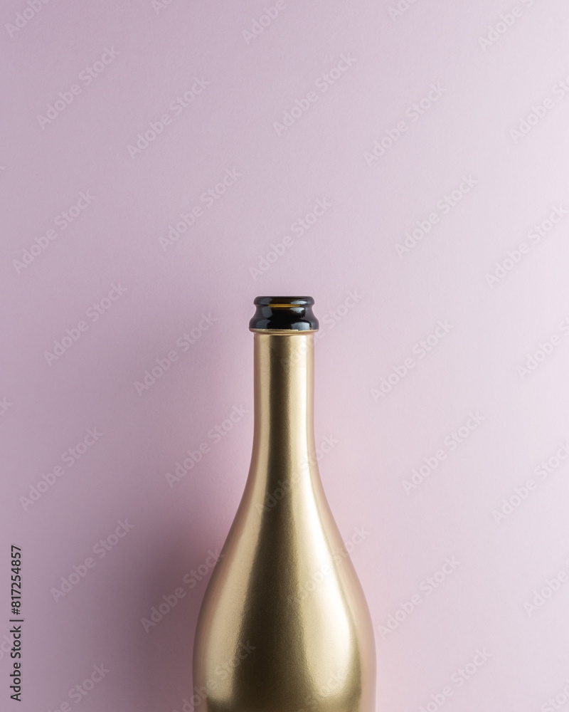 Golden champagne bottle on pink background. Minimal celebration concept. Golden champagne bottle on pink background. Minimal celebration concept.