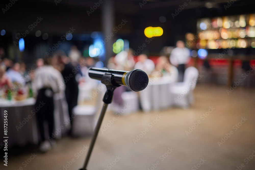 Microphone on stand before crowd, part of public address system at event Microphone on stand before crowd, part of public address system at event