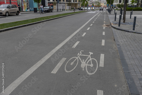 Wallpaper Mural A well-marked bike lane on an urban road with clear road markings, a bicycle symbol, and white lines indicating the direction of traffic. The scene is devoid of people Torontodigital.ca