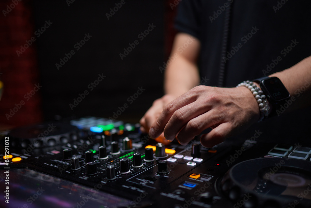 control DJ for mixing music with blurred people dancing at party in nightclub. control DJ for mixing music with blurred people dancing at party in nightclub.