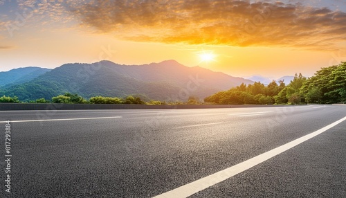 straight asphalt highway road and mountain nature background at sunset