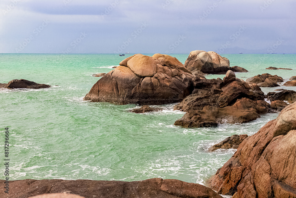 View of large rocks along the shore of the South China Sea. Sky Grottoes Park, Sanya, China View of large rocks along the shore of the South China Sea. Sky Grottoes Park, Sanya, China