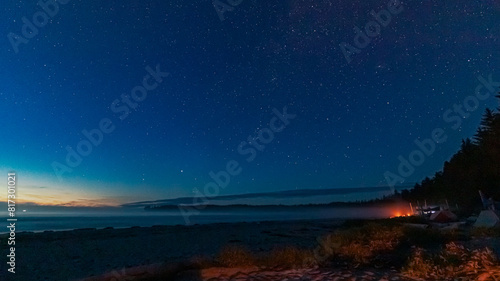 West coast beach with campers and fire at night with stars