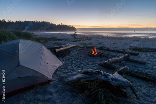 West coast beach at night with campfire and tent