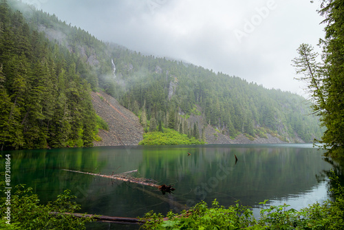 mountain lake with fog and waterfall