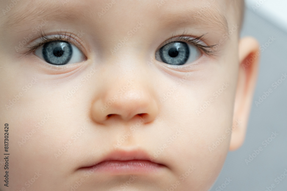 Close-up of a toddler baby gazing at the camera with calm face Close-up of a toddler baby gazing at the camera with calm face