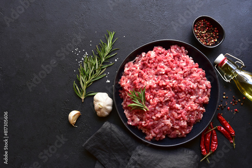 Homemade minced meat with ingredients for making in a bowl . Top view.