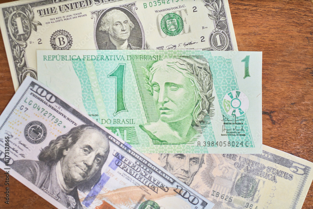 Comparison of dollar bill with brazilian real, concept of inflation or abundance Comparison of dollar bill with brazilian real, concept of inflation or abundance